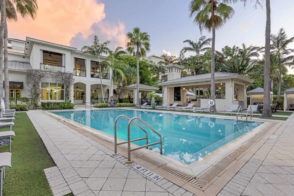Pool with deck seating, covered cabanas, and covered pavilion
