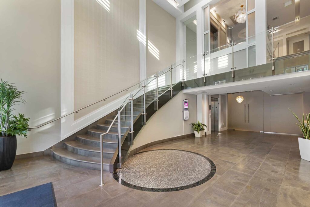Clubhouse lobby with large staircase leading to mezzanine level