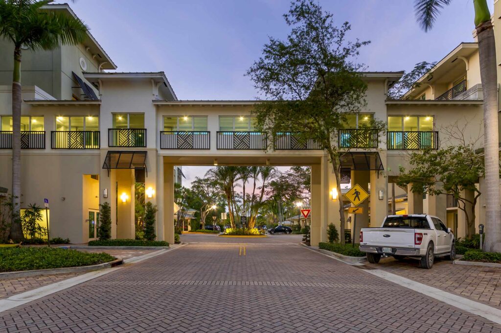 Building exterior showing large trees and lots of balconies