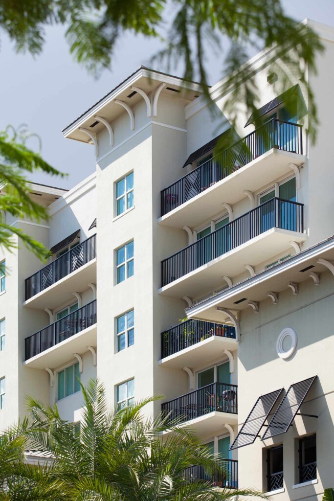 Building exterior showing large trees and lots of balconies