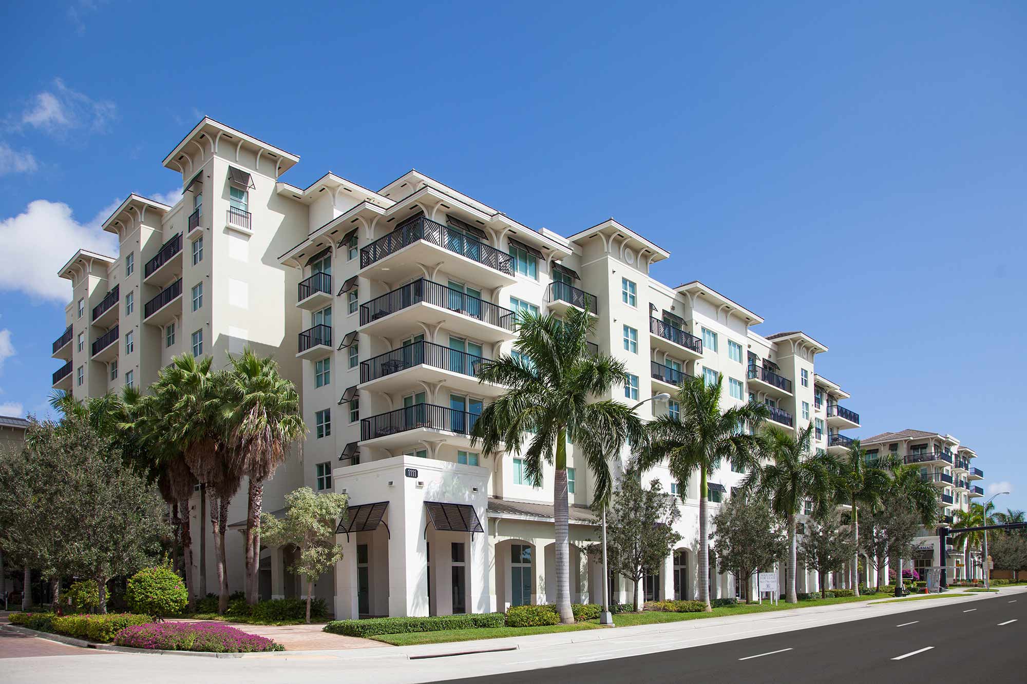 Building exterior showing large trees and lots of balconies