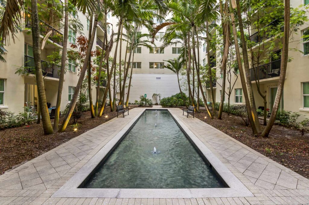 Courtyard with palm trees and long shallow fountain