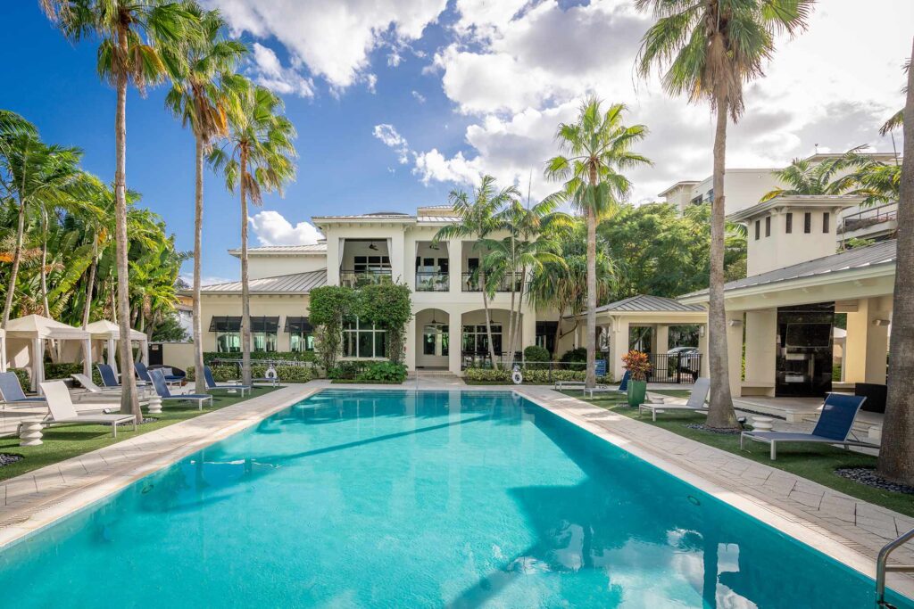 Pool with deck seating, covered cabanas, and covered pavilion