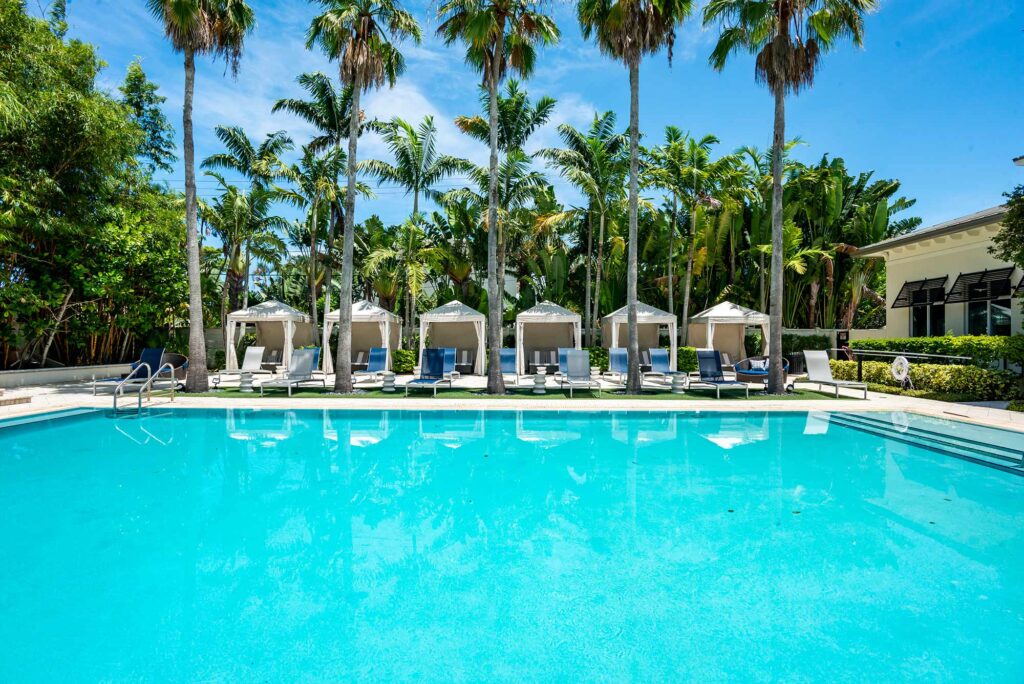 Pool with deck seating, covered cabanas, and covered pavilion
