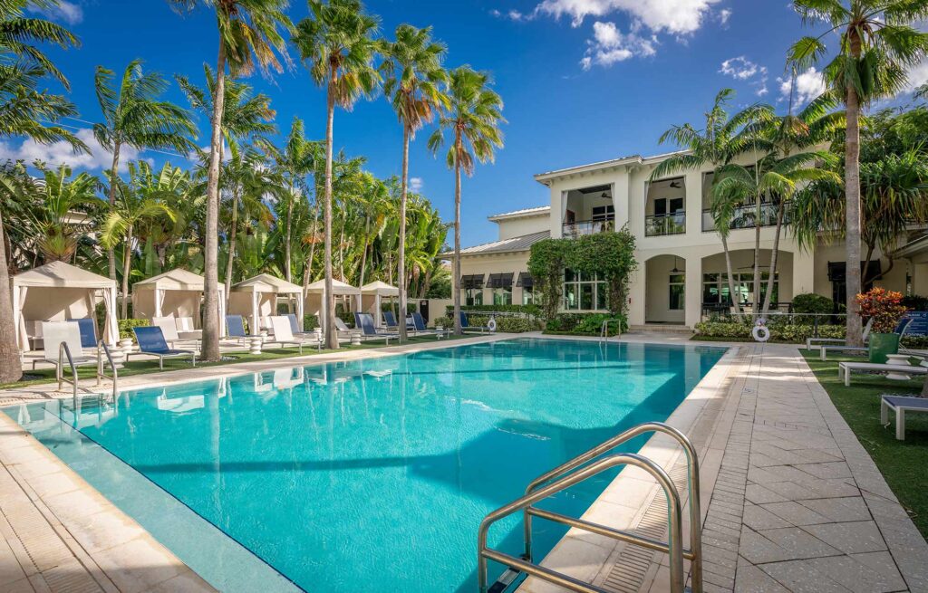 Pool with deck seating, covered cabanas, and covered pavilion