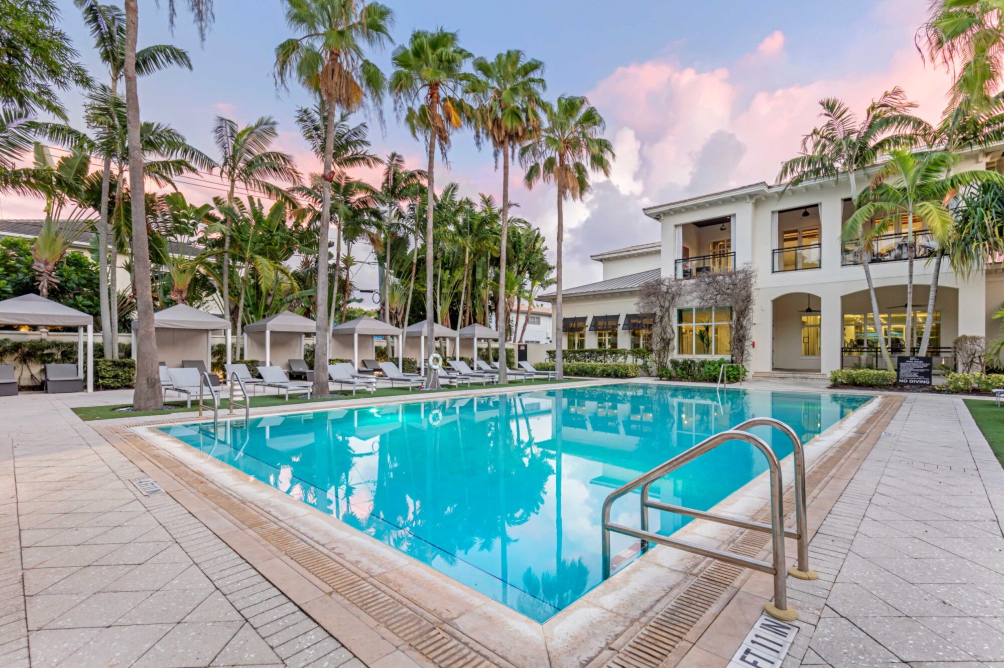 Pool with deck seating, covered cabanas